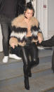 <p>Kardashian stepped out in N.Y.C. wearing leather pants and a chic fur coat over a nude shirt. She accessorized the look with a black choker and envelope purse.</p>