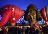 Hot air balloons, shaped like the Nelly-B and Darth Vader characters, are displayed during a night glow on the evening of Day 3 of the Canadian Hot Air Balloon Championships in High River September 27, 2013. Spectators had the opportunity to walk among the balloons which do not actually launch. The launches during the day will determine qualifiers for the World Hot Air Balloon Championships in Sao Paulo in 2014. REUTERS/Mike Sturk (CANADA - Tags: SOCIETY)