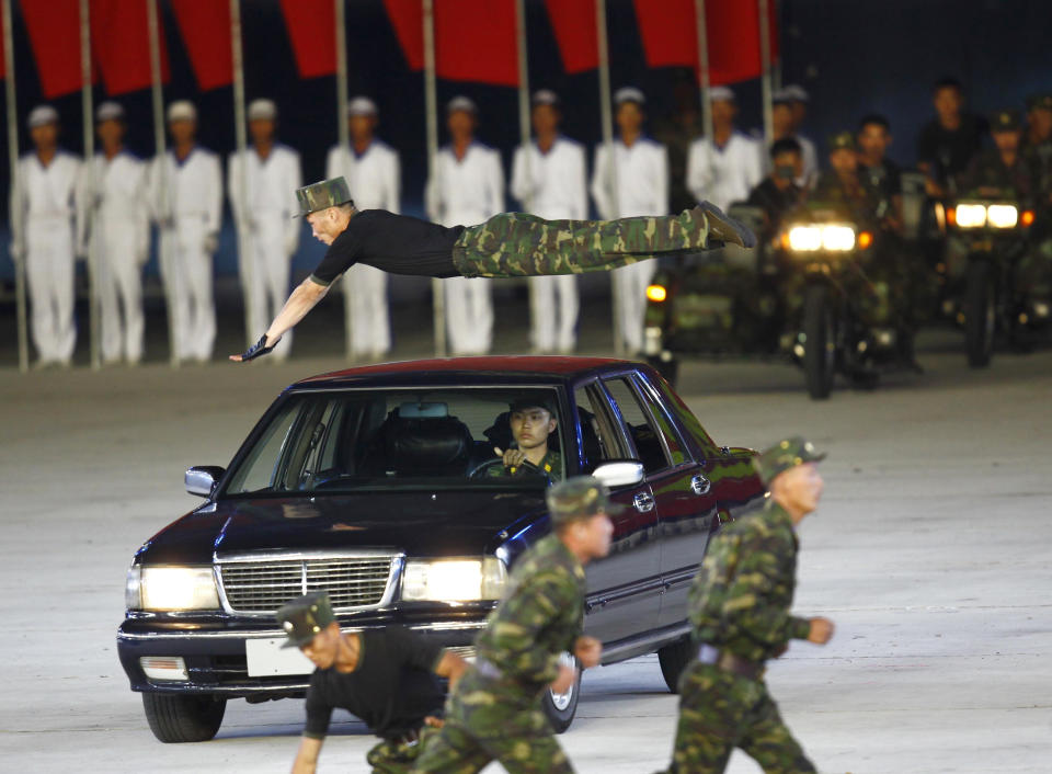 North Korean soldiers show their skills during a mass game performance of "The Land of the People" at the May Day Stadium in Pyongyang, North Korea, Tuesday, June 25, 2019. (AP Photo/Cha Song Ho)