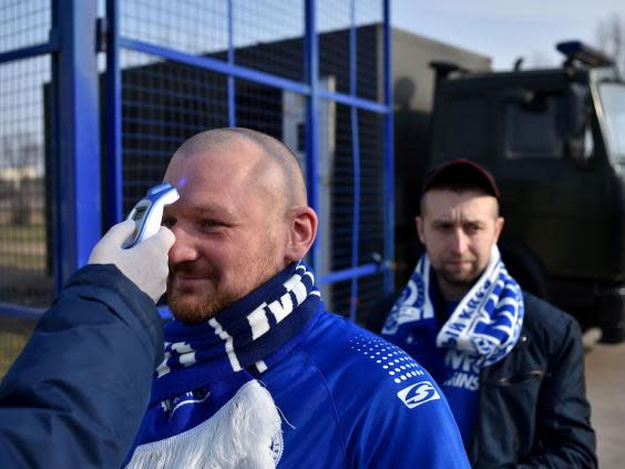 A fan has his temperature checked before entering the stadium (Getty)