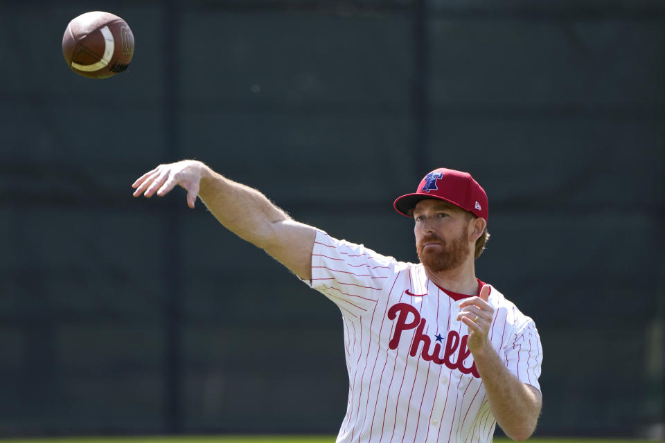 Philadelphia Phillies pitcher Spencer Turnbull throws a football during a baseball spring training workout Wednesday, Feb. 14, 2024, in Clearwater, Fla. (AP Photo/Charlie Neibergall)