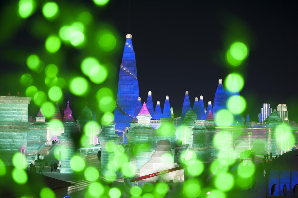 <p>Tourists visit illuminated ice sculptures at Ice and Snow World park on Jan. 4 in Harbin, China. (Photo: Tao Zhang/Getty Images) </p>
