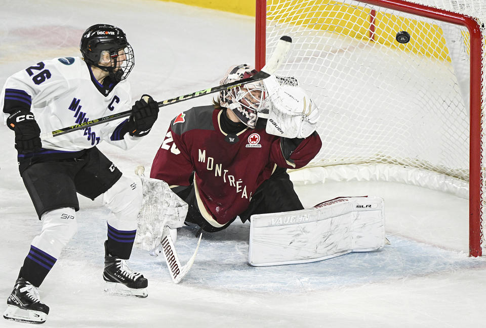 Minnesota's Kendall Coyne Schofield (26) scores against Montreal goaltender Elaine Chuli during the first period of a PWHL hockey game in Laval, Quebec, Sunday, Feb. 18, 2024. (Graham Hughes/The Canadian Press via AP)