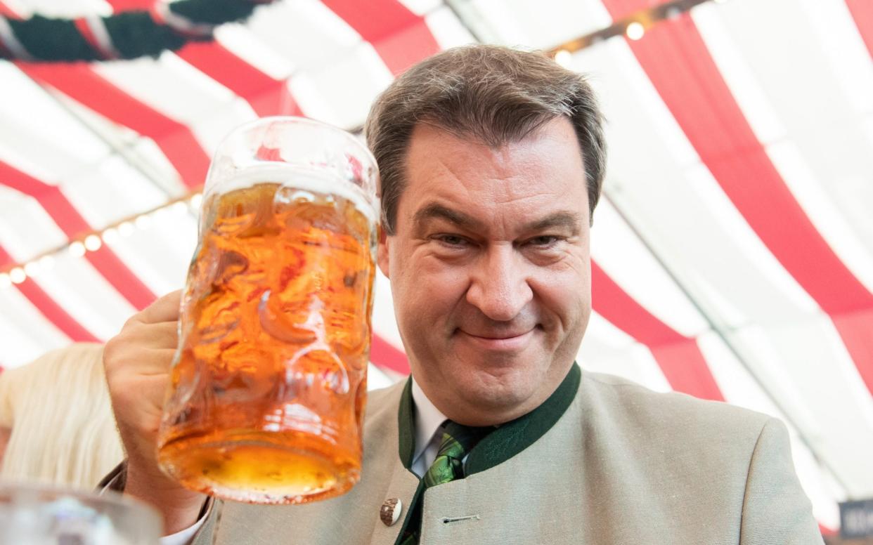 Marcus Söder, enjoying a drink at a Bavarian festival two years ago, has emerged as a surprise possible successor to Angela Merkel - Sebastian Widmann/Getty Images Europe