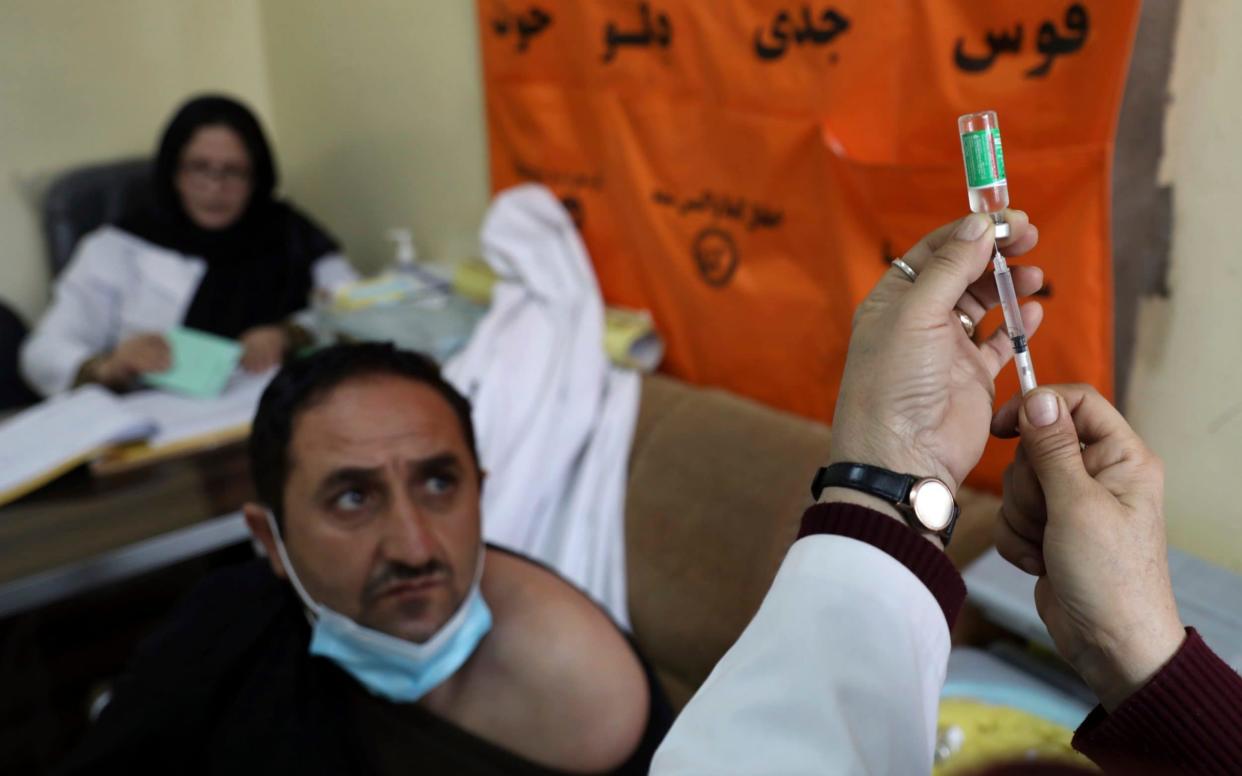 A man waits to be given the AstraZeneca vaccine at a hospital in Kabul, Afghanistan - Rahmat Gul /AP