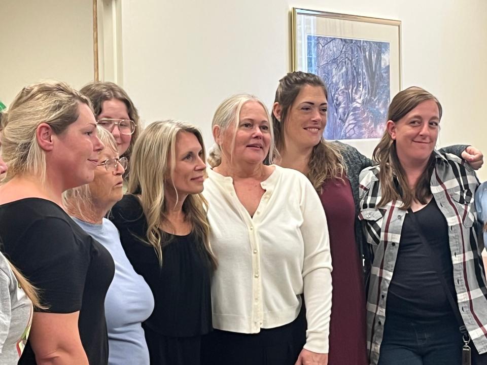 Donna Johnson (center), the mother of Paige Johnson — a Northern Kentucky teen who vanished nearly 13 years ago, poses with her family after a Clermont County jury returned a guilty verdict against Jacob Bumpass.