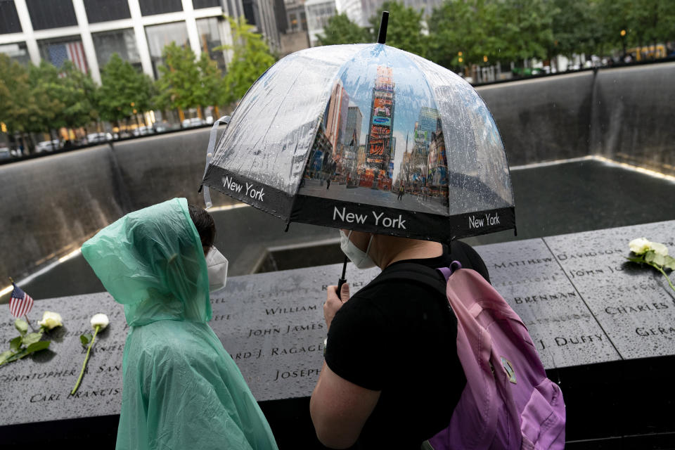 Visitors browse the south pool at the National September 11 Memorial & Museum, Thursday, Sept. 9, 2021, in New York. (AP Photo/John Minchillo)