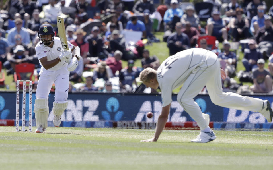 India's Cheteshwar Pujara, left, plays the ball past New Zealand blower Kyle Jamieson during play on day one of the second cricket test between New Zealand and India at Hagley Oval in Christchurch, New Zealand, Saturday, Feb. 29, 2020. (AP Photo/Mark Baker)