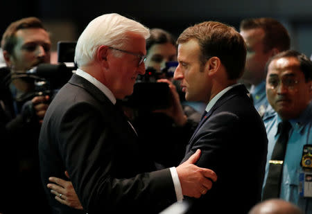 German President Frank-Walter Steinmeier hugs French President Emmanuel Macron as they attend the COP23 U.N. Climate Change Conference in Bonn, Germany, November 15, 2017. REUTERS/Wolfgang Rattay