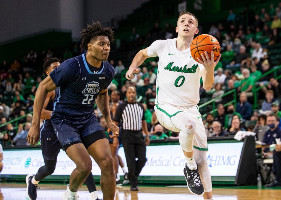 Marshall's Andrew Taylor (0) drives to the rim against Old Dominion's Kalu Ezikpe (22) during an NCAA men's basketball game on Thursday, Feb. 17, 2022, at the Cam Henderson Center in Huntington./The Herald-Dispatch via AP)