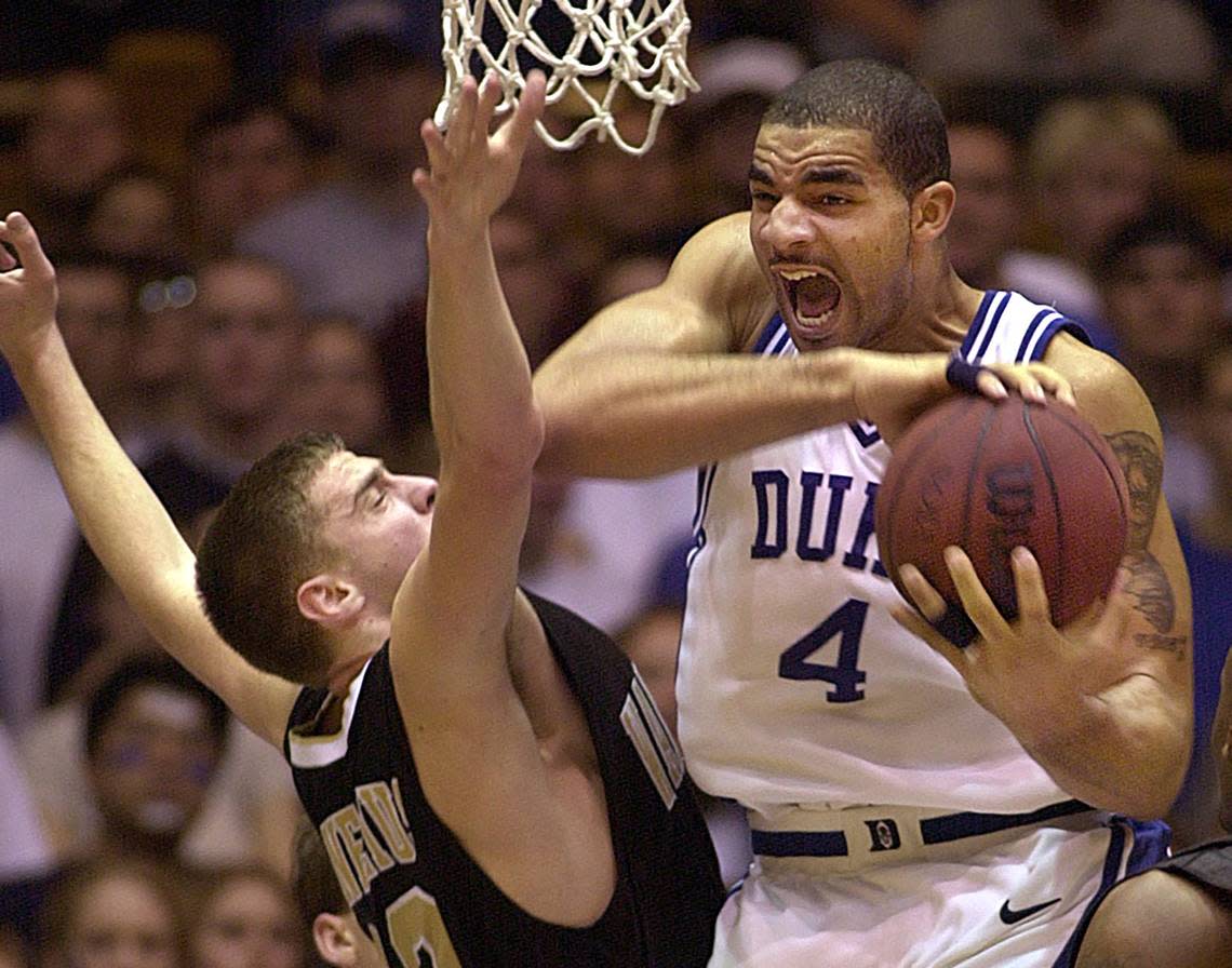 Duke’s Carlos Boozer pulls a rebound from Wake Forest’s Vytas Danelius during a game in 2002. Chuck Liddy/News & Observer file photo
