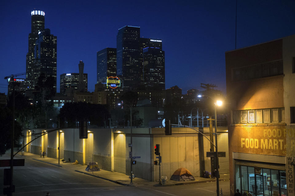 FILE - In this April 25, 2016, file photo, homeless people sleep in the Skid Row area of downtown Los Angeles. A federal judge overseeing a sweeping lawsuit about homelessness in Los Angeles on Tuesday, April 20, 2021, ordered the city and county to find shelter for all unhoused residents of Skid Row within 180 days and audit any spending related to the out-of-control crisis of people living on the streets. (AP Photo/Jae C. Hong, File)