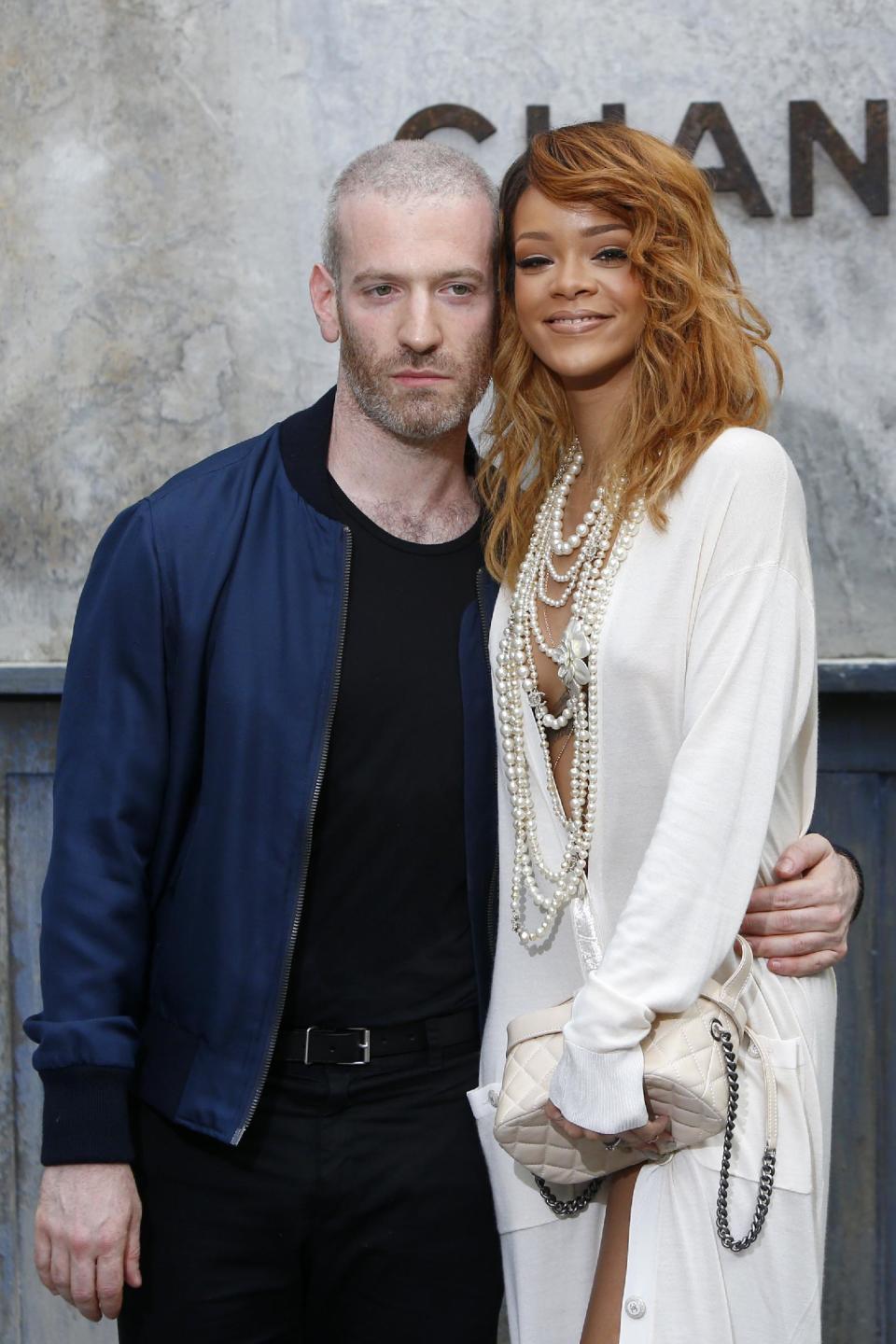 Singer Rihanna, right, and Mel Ottenberg pose for photographers as they arrive to attend Chanel's Haute Couture Fall-Winter 2013-2014 collection, presented Tuesday, July 2, 2013 in Paris. (AP Photo/Francois Mori)