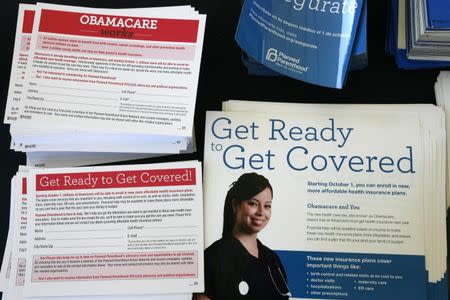 Information cards are stacked on a table during an Affordable Care Act outreach event for the Latino community in Los Angeles, California September 28, 2013. REUTERS/Jonathan Alcorn