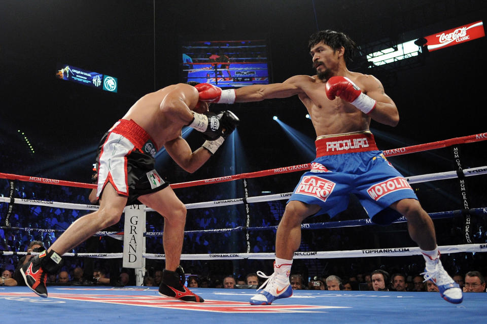 LAS VEGAS, NV - NOVEMBER 12: (R-L) Manny Pacquiao throws a right to the body of Juan Manuel Marquez during the WBO world welterweight title fight at the MGM Grand Garden Arena on November 12, 2011 in Las Vegas, Nevada. (Photo by Harry How/Getty Images)