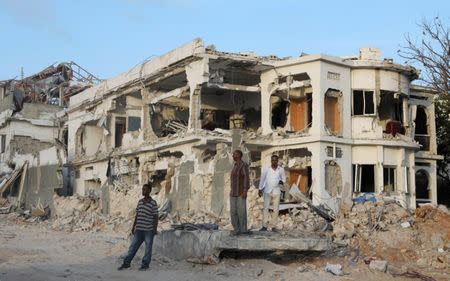 Somali businessmen stand near the scene of last Saturday explosion in KM4 street in the Hodan district in Mogadishu, Somalia October 17, 2017. REUTERS/Feisal Omar