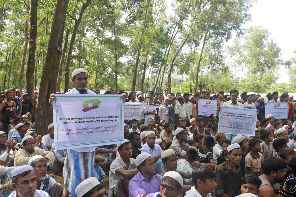 Rohingya refugees hold placards during a gathering to mark the fifth anniversary of their exodus from Myanmar to Bangladesh, at a Kutupalong Rohingya refugee camp at Ukhiya in Cox's Bazar district, Bangladesh, Thursday, Aug. 25, 2022. Hundreds of thousands of Rohingya refugees on Thursday marked the fifth anniversary of their exodus from Myanmar to Bangladesh, while the United States, European Union and other Western nations pledged to continue supporting the refugees' pursuit of justice in international courts.(AP Photo/ Shafiqur Rahman)