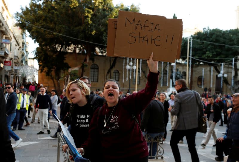 Demonstrators shout as the maltese businessman Yorgen Fenech, who was arrested in connection with an investigation into the murder of journalist Daphne Caruana Galizia, leaves the Courts of Justice in Valletta