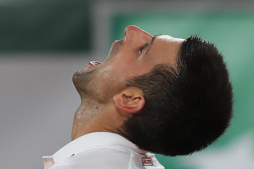 Serbia's Novak Djokovic reacts after missing a shot against Sweden's Mikael Ymer in the first round match of the French Open tennis tournament at the Roland Garros stadium in Paris, France, Tuesday, Sept. 29, 2020. (AP Photo/Michel Euler)