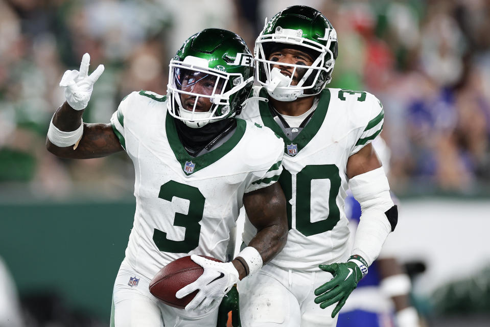 New York Jets safety Jordan Whitehead (3) and cornerback Michael Carter II (30) celebrate after Whitehead intercepted a pass against the Buffalo Bills during the third quarter of an NFL football game, Monday, Sept. 11, 2023, in East Rutherford, N.J. (AP Photo/Adam Hunger)