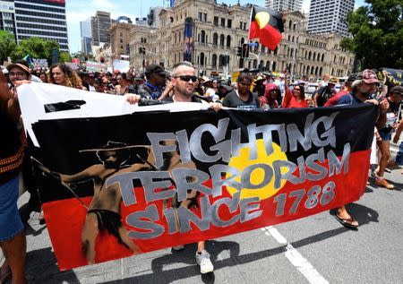 People hold signs and yell slogans as they join Aboriginal protesters in their march on Australia Day in central Brisbane, Australia, January 26, 2017. AAP/Dan Peled/via REUTERS