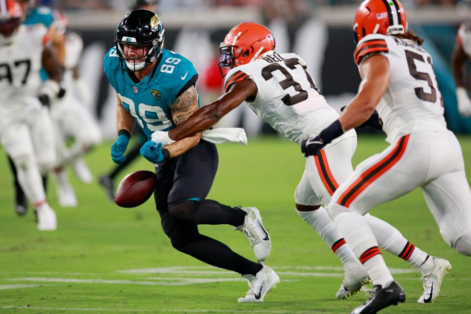 Browns safety D'Anthony Bell (37) forces a fumble by Jaguars tight end Luke Farrell during the third quarter of a preseason game, Aug. 12, 2022, in Jacksonville.