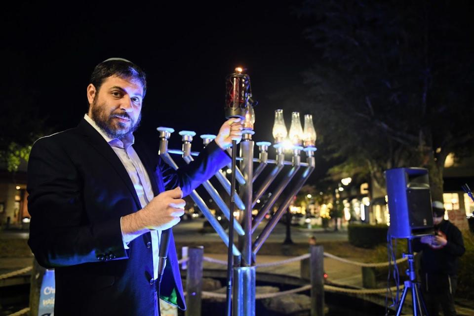 Rabbi Shmuli Novack of Chabad of Jacksonville lights the menorah at St. Johns Town Center in 2022.