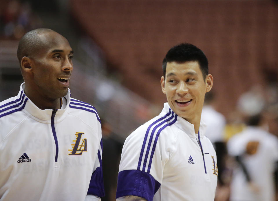 Los Angeles Lakers' Jeremy Lin smiles whilte talking to Kobe Bryant before a preseason NBA basketball game against the Phoenix Suns on Tuesday, Oct. 21, 2014, in Anaheim, Calif. (AP Photo/Jae C. Hong)