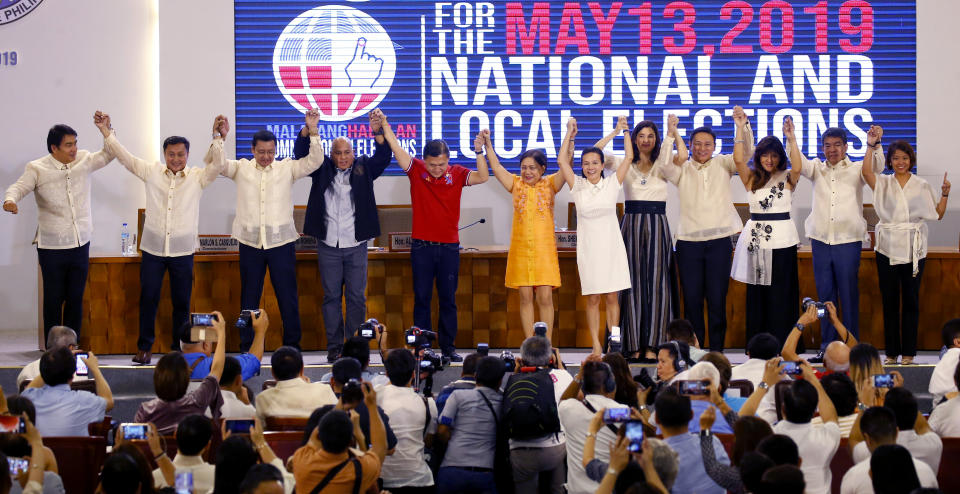 Twelve newly-proclaimed senators raise their hands during a ceremony at the Commission on Elections in suburban Pasay city south of Manila, Philippines Wednesday, May 22, 2019. They are, from left, Senators Bong Revilla, Francis Tolentino, Lito Lapid, Ronald Dela Rosa, Christopher Go, Cynthia Villar, Grace Poe, Pia Cayetano, Sonny Angara, Imee Marcos, Aquilino Pimentel and Nancy Binay. (AP Photo/Bullit Marquez)