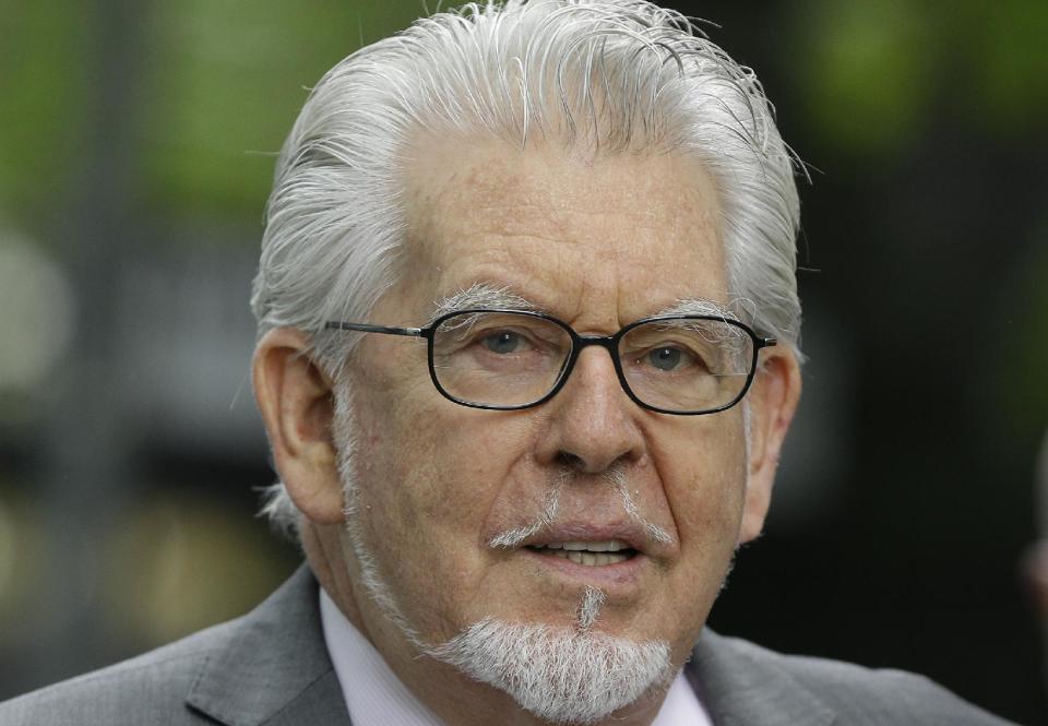 Veteran Australian-British entertainer Rolf Harris who is accused of indecent assault arrives at Southwark Crown Court in London, Friday, May 9, 2014. The 84-year-old is charged with indecently assaulting four girls between 1968 and 1986. The girls ranged in age from 7 or 8 to 19. Harris denies the charges. (AP Photo/Kirsty Wigglesworth)