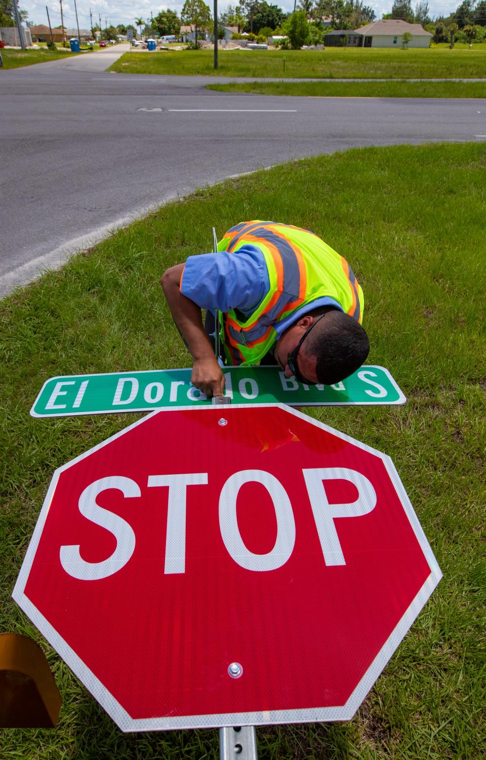Edwin Castro, a traffic engineer for the City of Cape Coral, prepares new traffic signs at the intersection of El Dorado Parkway and SW 2nd Terrace on Friday July 8, 2022.