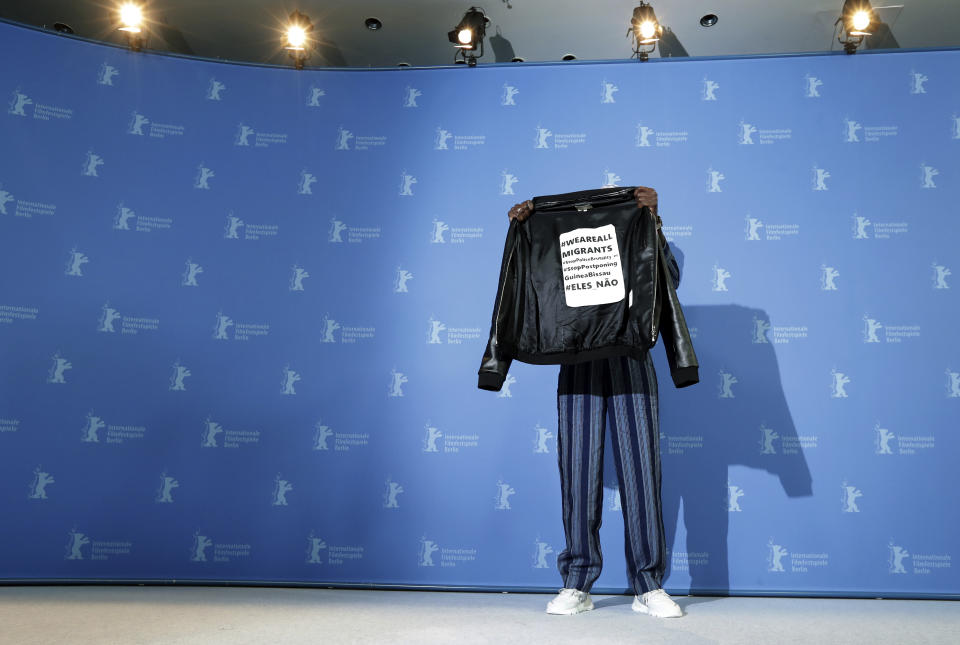 Actor Welket Bungue poses for the photographers during a photo call for the film 'Berlin Alexanderplatz' at the 70th International Film Festival, Berlinale, in Berlin, Germany, Wednesday, Feb. 26, 2020. (AP Photo/Michael Sohn)