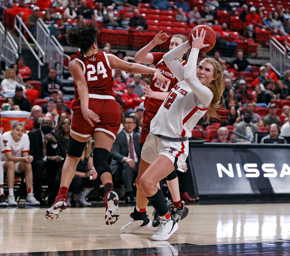 Texas Tech's Vivian Gray (12) steps away from Oklahoma's Skylar Vann (24) and Taylor Robertson (30) during the second half of an NCAA college basketball game on Sunday, Jan. 2, 2022, in Lubbock, Texas.