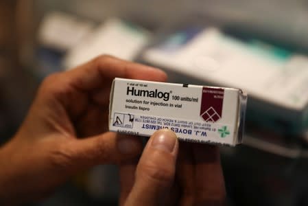 Georgina holds a box containing insulin medicine in London