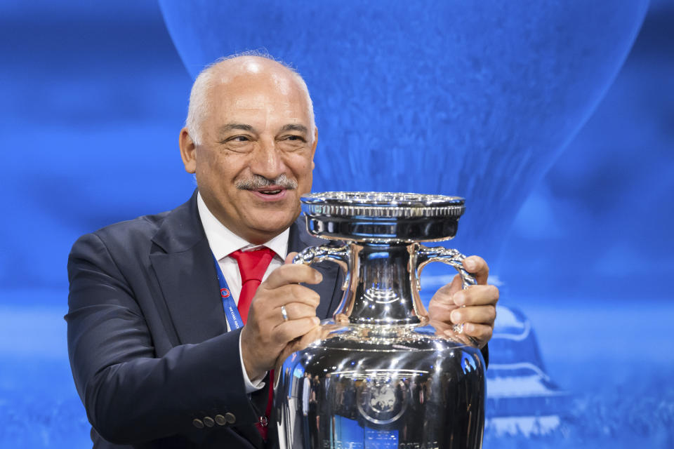 Mehmet Buyukeksi, President of the Turkish Football Federation (TFF), poses with the trophy after Italy and Turkey were elected to host the Euro 2032 fooball tournament during the the UEFA EURO 2028 and 2032 hosts announcement ceremony after the UEFA Executive Committee, at UEFA Headquarters, in Nyon, Switzerland, Tuesday, October 10, 2023. UEFA has decided the future of soccer’s European Championship for the next decade. The United Kingdom and Ireland will host in 2028 and an unusual Italy-Turkey co-hosting plan was picked for 2032. (Jean-Christophe Bott/Keystone via AP)