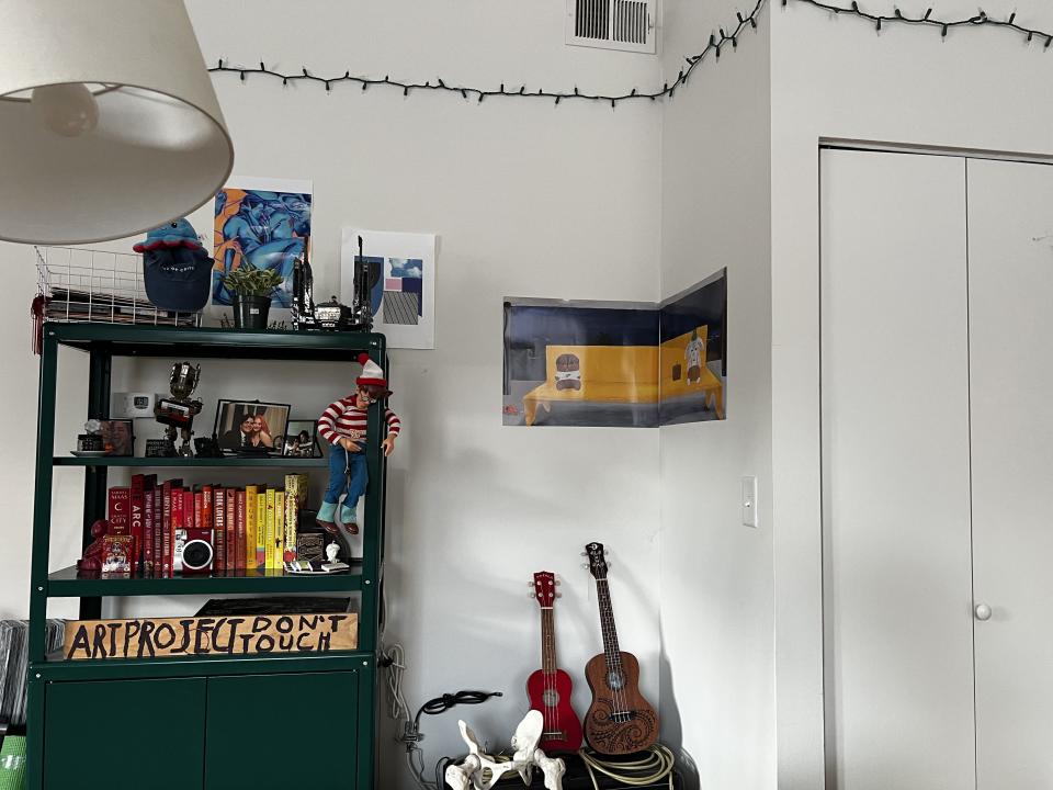 Green shelves with books and trinkets.