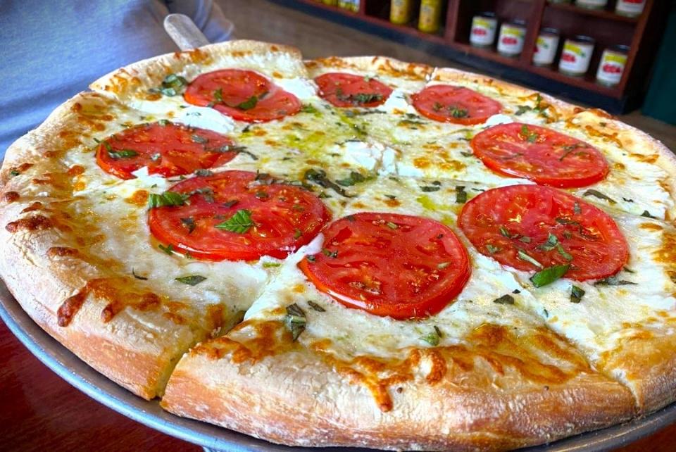 The Margherita pizza at El Marie deviates from traditional recipes by offering mozzarella and ricotta along with the standard tomato and basil.