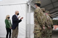 President Joe Biden and first lady Jill Biden meet with troops at a FEMA COVID-19 mass vaccination site at NRG Stadium, Friday, Feb. 26, 2021, in Houston. (AP Photo/Patrick Semansky)