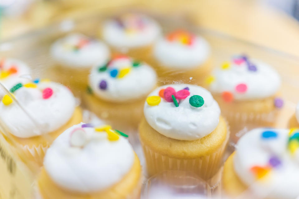 Macro closeup of light yellow iced cupcakes in box