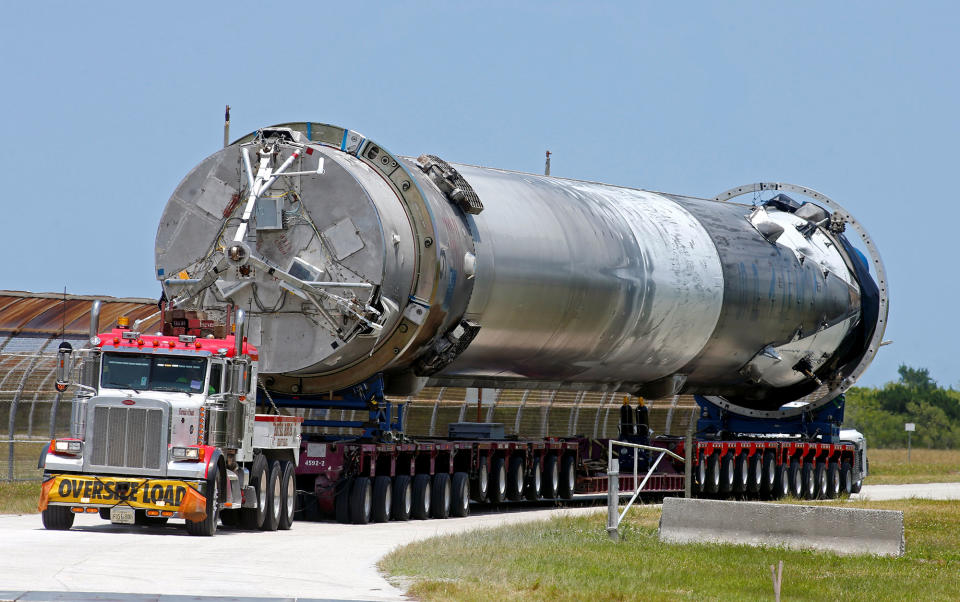 The recovered first stage of a SpaceX Falcon 9 rocket is transported to the SpaceX hangar at launch pad 39A at the Kennedy Space Center in Cape Canaveral