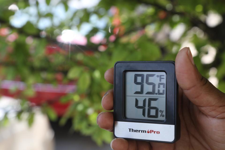 A thermometer reads 95 degrees in the shade under one of the few trees in this section of Newark, one of the hottest areas in a city considered one of the worst heat islands in the United States here. July 1, 2022.