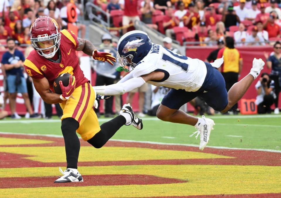 USC receiver Michael Jackson III catches a touchdown pass against Nevada's KK Meier