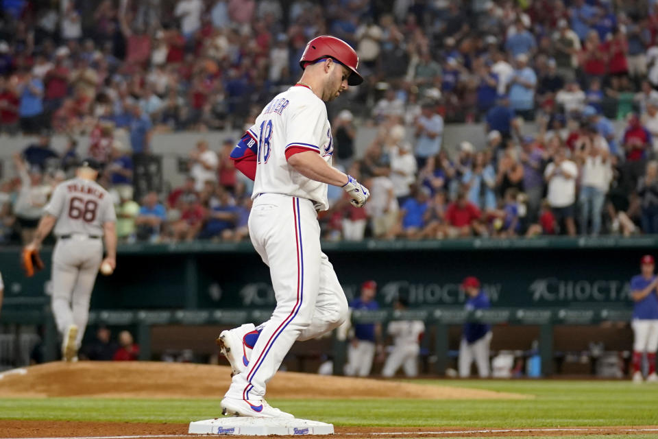 Texas Rangers' Mitch Garver, foreground, rounds third on his way home after hitting a solo home run off Houston Astros starting pitcher J.P. France (68) in the sixth inning of a baseball game, Monday, Sept. 4, 2023, in Arlington, Texas. (AP Photo/Tony Gutierrez)