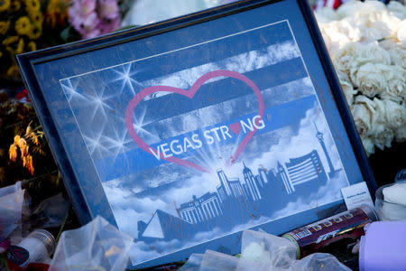 A "Vegas Strong" illustration is shown among flowers under the "Welcome to Las Vegas" sign in Las Vegas, Nevada U.S. October 9, 2017. REUTERS/Las Vegas Sun/Steve Marcus NO RESALES. NO ARCHIVE.