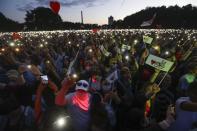 Belarusians attend a meeting in support of Svetlana Tikhanovskaya, candidate for the presidential elections in Minsk, Belarus, Thursday, July 30, 2020. Tikhanovskaya said she would not cancel any campaign rallies because of the stricter security. Thousands of Tikhanovskaya's supporters gathered Thursday at her campaign rally in Minsk, and many participants dismissed the official claims of a Russian subversion plot as a sham. The presidential election in Belarus is scheduled for August 9, 2020. (AP Photo/Sergei Grits)