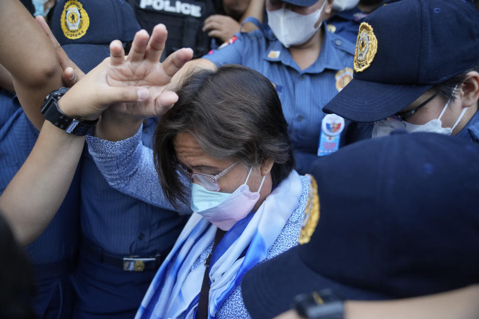 Detained former opposition Sen. Leila de Lima walks under tight security after she went for a court hearing which was later postponed in Muntinlupa, Philippines, Monday, Oct. 10, 2022. Human rights activists pressed their call Monday for the immediate release of de Lima after she was taken hostage in a rampage by three Muslim militants in a failed attempt to escape from a maximum-security jail. (AP Photo/Aaron Favila)