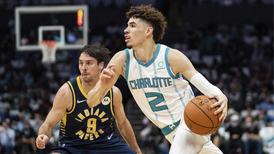 Charlotte Hornets guard LaMelo Ball (2) drives to the basket while guarded by Indiana Pacers guard T.J. McConnell (9) during the first half of an NBA basketball game in Charlotte, N.C., Wednesday, Oct. 20, 2021.