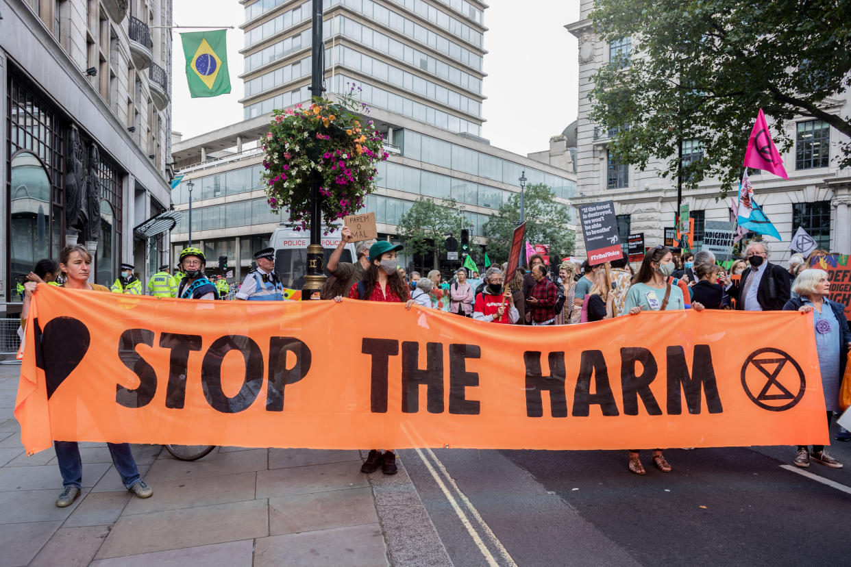 LONDON, UNITED KINGDOM - 2021/08/25: Protesters hold a banner expressing their opinions during the demonstration.
On the 3rd day of Extinction Rebellion's protests, protesters came together with the aim of demanding climate justice for the Indigenous people of Amazon rainforests in Brazil. They protest against ecocide and deforestation in Brazil. The group began their demonstration outside Brazilian Embassy in London, then moved over to Piccadilly Circus, and lastly occupying Oxford Circus. (Photo by Belinda Jiao/SOPA Images/LightRocket via Getty Images)