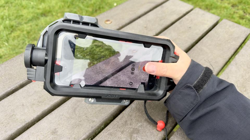 Joby SeaPal waterproof case held in a pair of hands