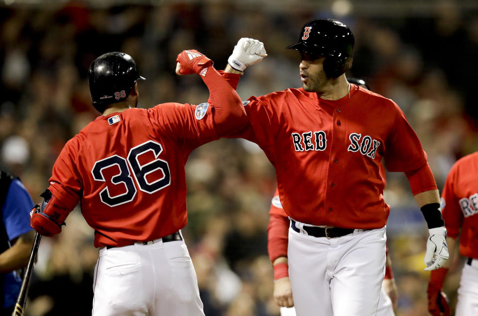 Boston Red Sox's J.D. Martinez celebrates after his three-run home run with Eduardo Nunez during the first inning of Game 1 of a baseball American League Division Series against the New York Yankees on Friday, Oct. 5, 2018, in Boston. (AP Photo/Charles Krupa)